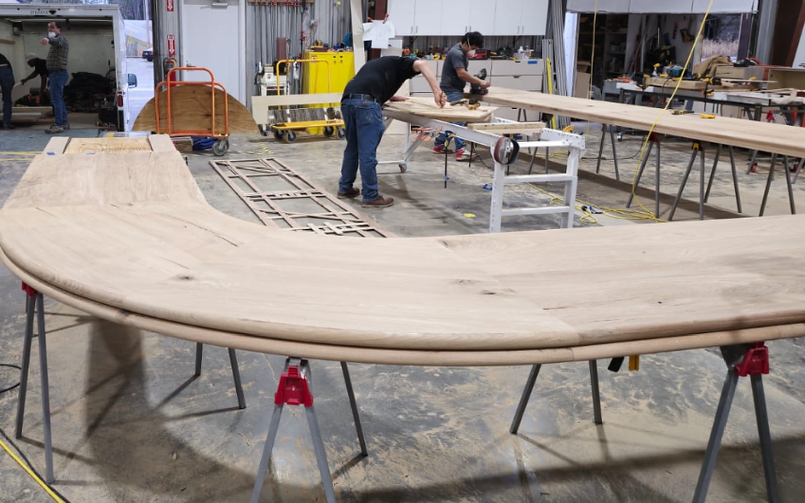 Curved bar top glued up and shaped to the radius on sawhorses in the shop